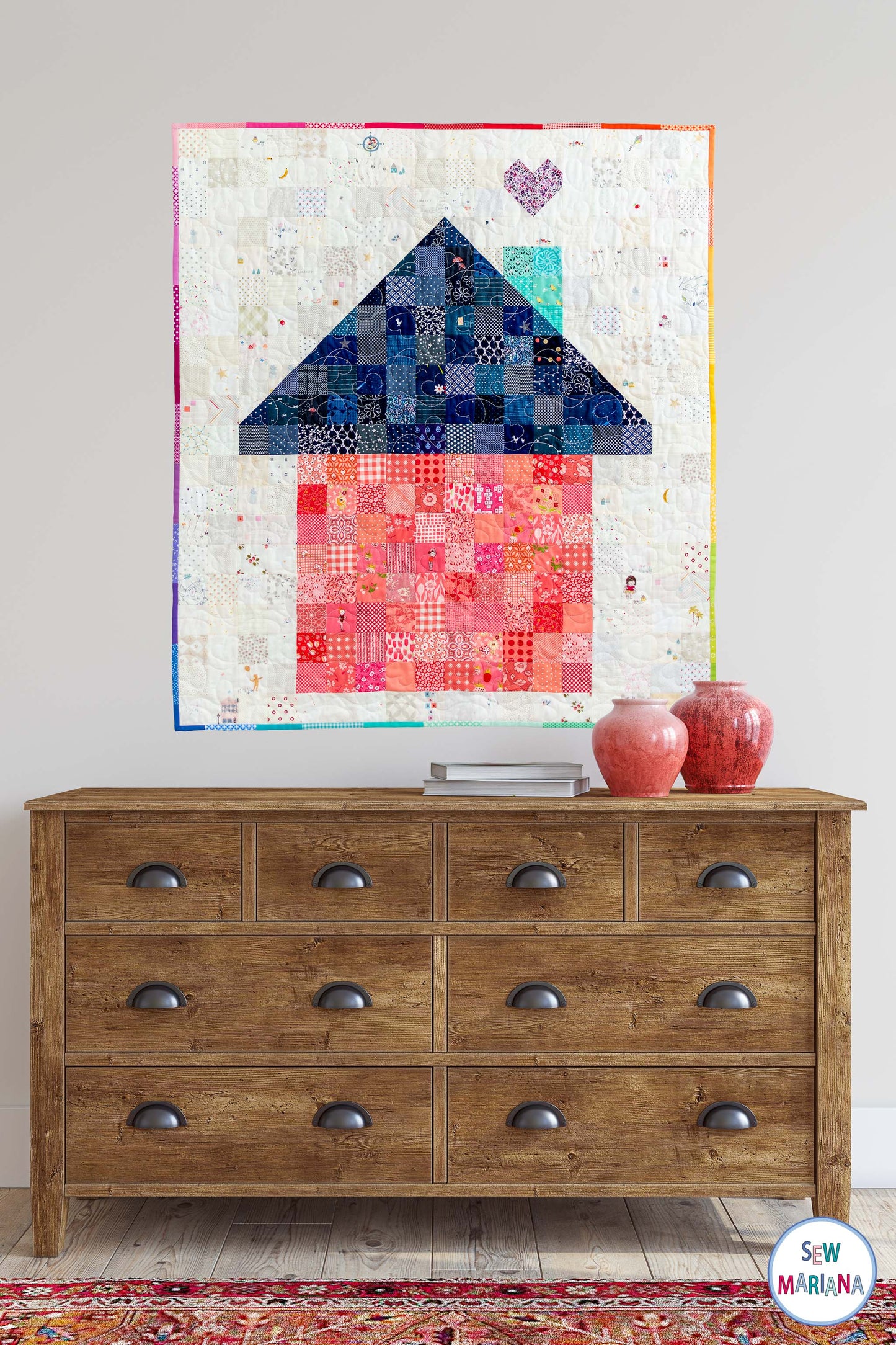 photo of the full house quilt baby size hanguing on the wall above a console table