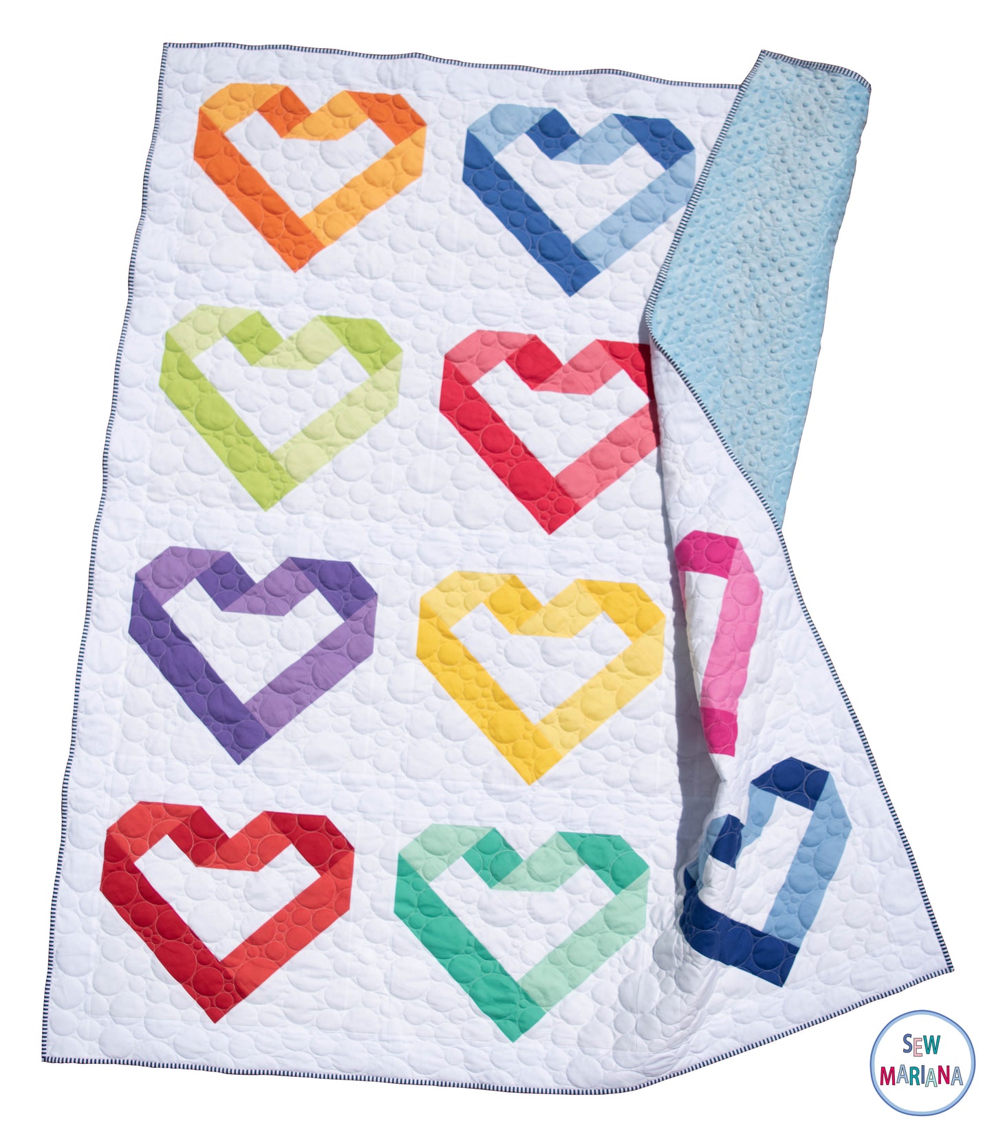 the in my heart quilt in rainbow colors floating on a white background showing the baby blue backing